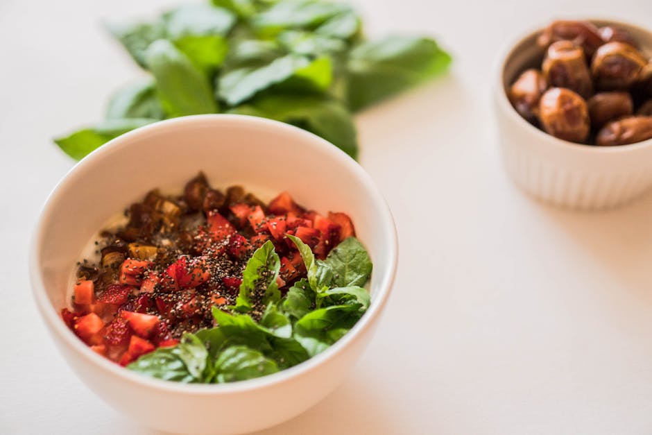 A vibrant salad bowl featuring fresh ingredients like basil, tomatoes, and chia seeds, perfect for a healthy meal.