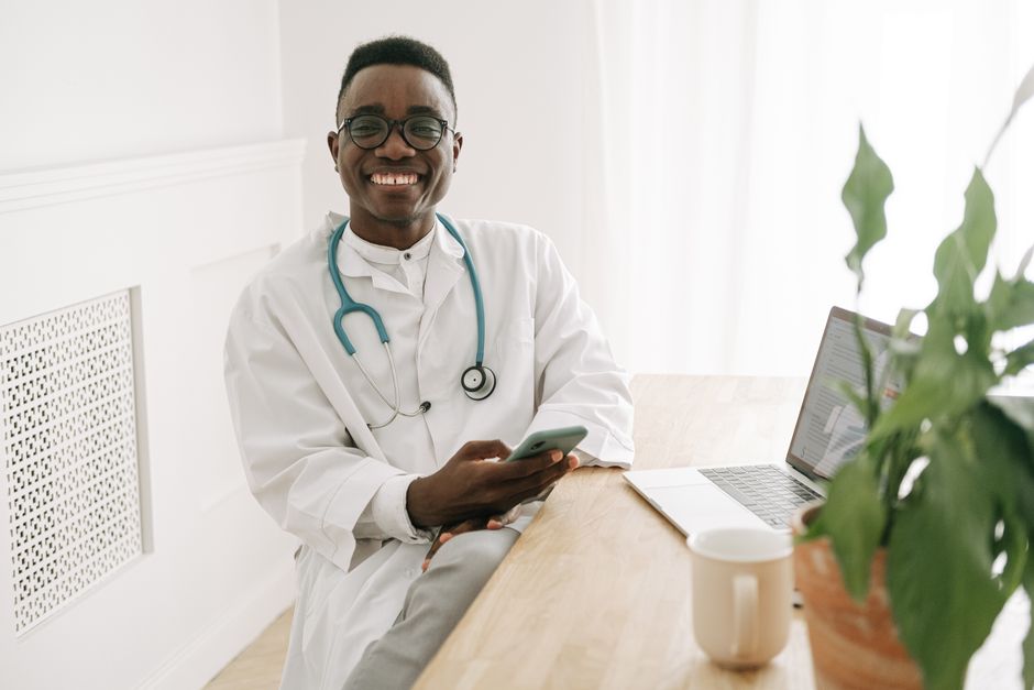 Doctor at desk using a smartphone in bright office