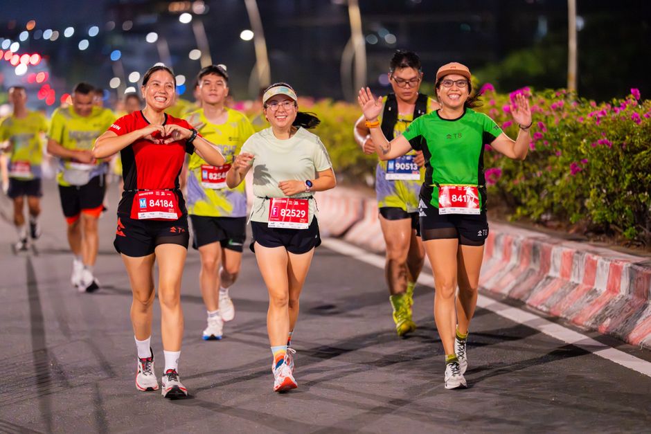 Dynamic image of marathon participants running outdoors at night, showcasing endurance and joy.