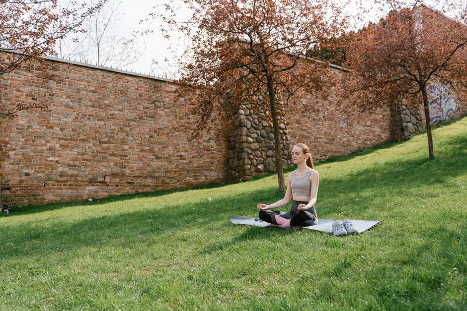 Meditation on a grassy field under blooming trees