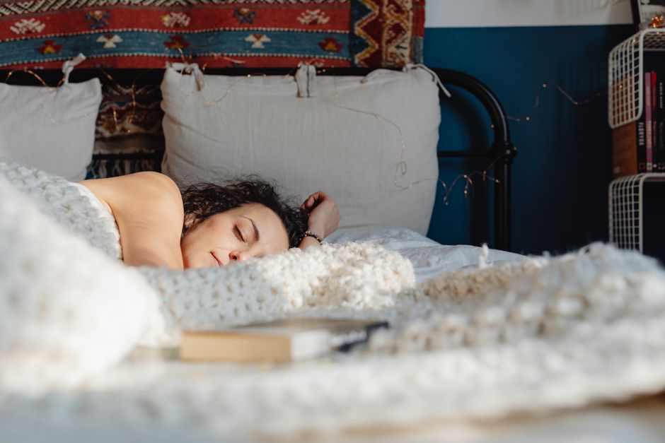 Woman sleeping peacefully in a sunlit bedroom